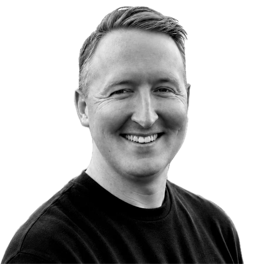 Chris Thurman, smiling, in a navy sweater